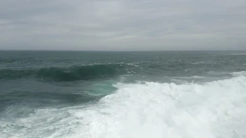 Large wave explodes onto a shallow reef. Aerial shot flying towards the Stock Footage 131611578