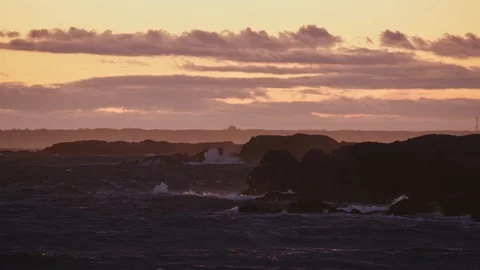 Large waves and choppy waters crash on the rocks of the New England Stock Footage 124998123