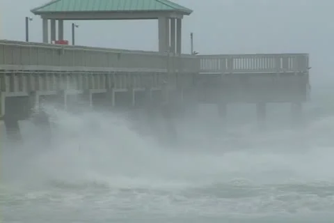 Large waves and high wind slams against a pier Stock-Footage 12575055
