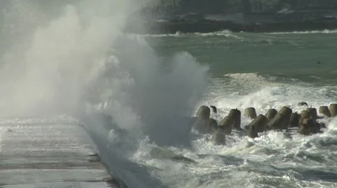 Large waves breaking over a seawall Stock Footage 8509725
