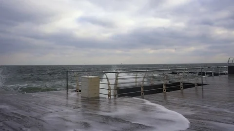 Large waves broken down with great force on the pier in slow motion Stock Footage 82523050