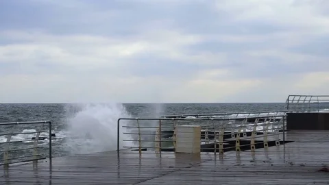Large waves broken down with great force on the pier in slow motion Stock Footage 82524388
