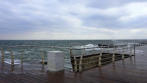 Large waves broken down with great force on the pier in slow motion Stock Footage 82525388