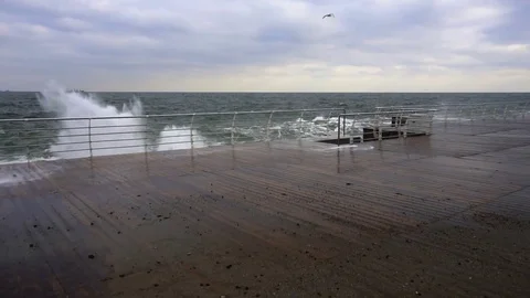 Large waves broken down with great force on the pier in slow motion Stock Footage 82525636