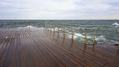 Large waves broken down with great force on the pier in slow motion Stock Footage 82528704
