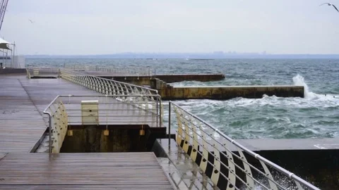 Large waves broken down with great force on the pier in slow motion Stock Footage 82530793