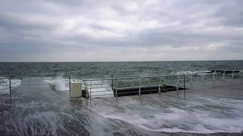 Large waves broken down with great force on the pier in slow motion Stock Footage 83094995