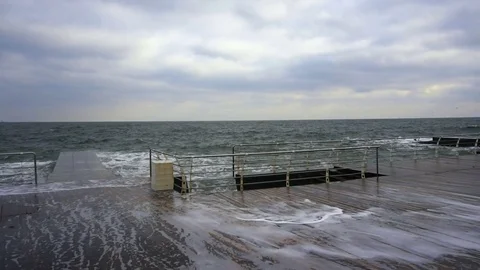 Large waves broken down with great force on the pier in slow motion Stock Footage 83095586