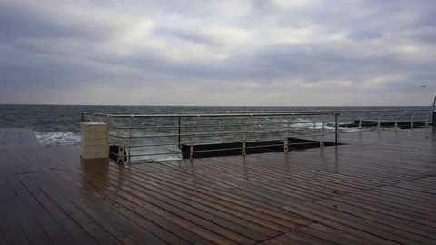 Large waves broken down with great force on the pier in slow motion Stock Footage 83096090