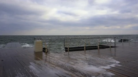 Large waves broken down with great force on the pier in slow motion Stock Footage 83097229