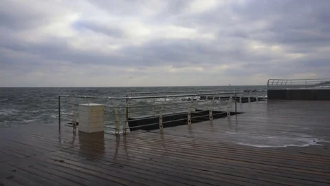 Large waves broken down with great force on the pier in slow motion Stock Footage 83097543