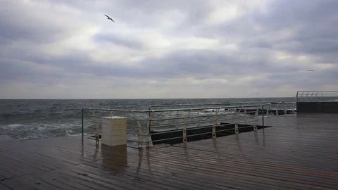 Large waves broken down with great force on the pier in slow motion Stock Footage 83097674