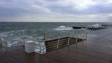 Large waves broken down with great force on the pier in slow motion Stock Footage 83097896