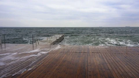 Large waves broken down with great force on the pier in slow motion Stock Footage 83098269