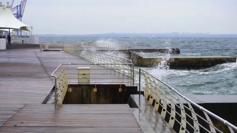 Large waves broken down with great force on the pier in slow motion Stock Footage 83098599