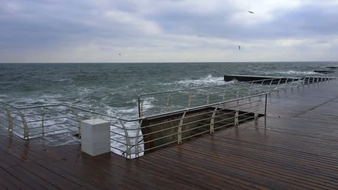 Large waves broken down with great force on the pier in slow motion Stock Footage 83506423