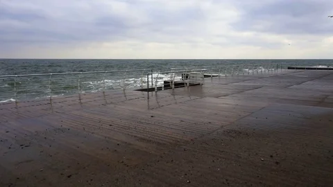 Large waves broken down with great force on the pier in slow motion Stock Footage 83774365