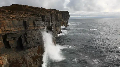 Large waves crash against rock cliffs in Orkney, Scotland Stock Footage 34515023