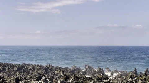 Large waves crashing over rocks. The turquoise blue water explodes into Stock Footage 281929275