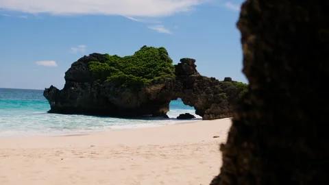 Large waves crashing on tropical beach with natural rock arch Sumba, Indonesia 스톡 동영상 341878069