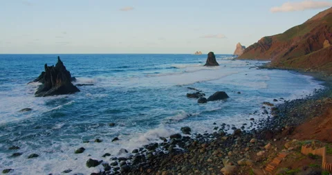Large waves with foam roll on hilly ocean rocky beach at sunset. Relax 4k enjoy Stock Footage 200623256