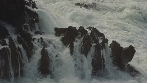 Large waves hitting sharp rocks on coast and draining Stock Footage 168802452