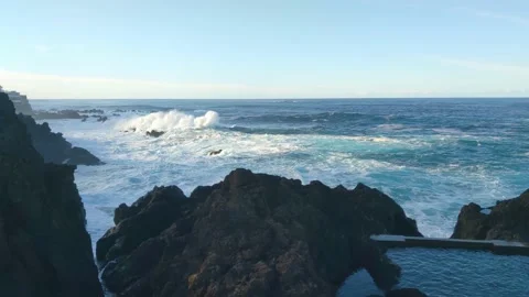 Large waves of ocean or sea crash against the rocky coast. Foam and splashes Stock Footage 236959380