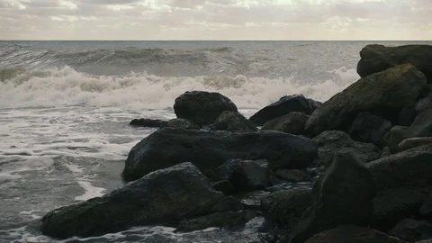 Large waves roll and crash against rocks slow motion Stock Footage 81557933