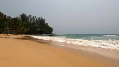 Large waves wash over a wide part of the beach. Stock Footage 242166956