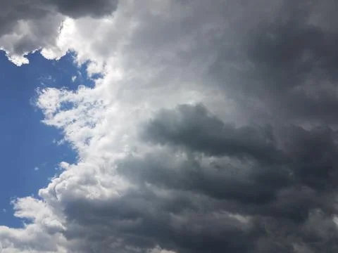 Large white and black cloud in blue sky Stock Photos
