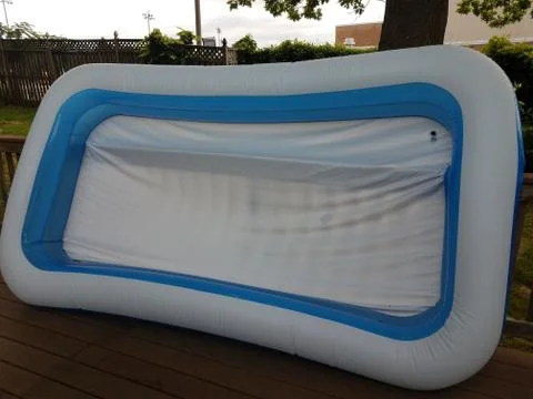 Large white and blue inflatable pool on deck Stock Photos