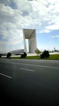 Large white architectural monument standing on green grass. 库存照片