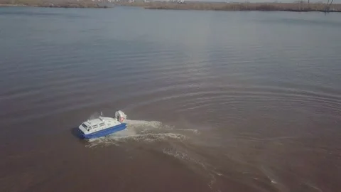 Large white blue hovercraft turns and creates splashes Stock Footage 155286471