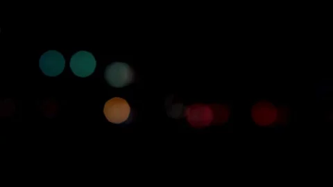 Large white blurred circles move on dark night street Stock Footage 329816030