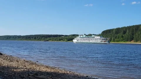 A large white boat is sailing up a blue river on a sunny summer day Stock Footage 315307703
