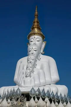 Large white buddha statue with multiple faces and golden crown Stock Photos