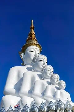 Large white buddha statue with multiple heads and golden top Stock Photos