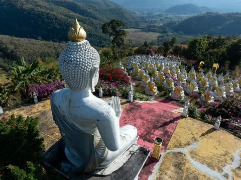 Large White Buddha Statue Overlooking Rows Of Smaller Statues In Phetchabun.. Stock Photos