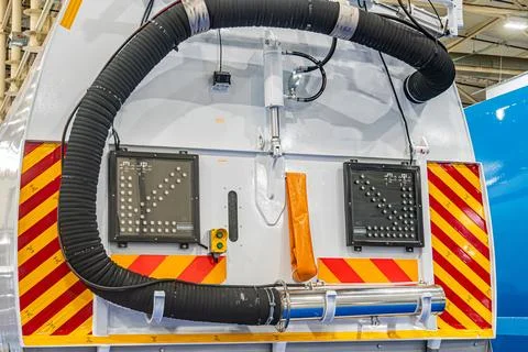 A large white circular mechanical component with ventilation holes, accompani Stock Photos