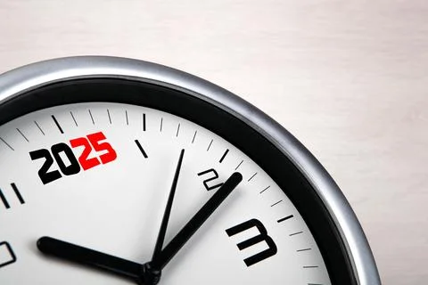 Large white clock face with digits on a wooden background closeup Stock-Fotos