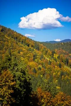 Large white cloud in the blue sky, mountain landscape on a sunny autumn day. Stock Photos