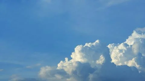 A large white cloud is in the lower right corner of the image. There is a bla Stock Photos