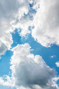 Large white clouds against a blue sky Stock Photos