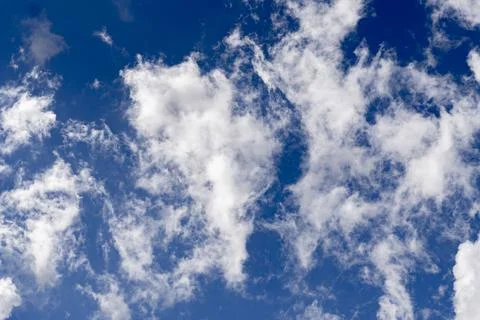 Large white clouds against a blue sky. Huge clouds like cotton wool in the sky Stock Photos