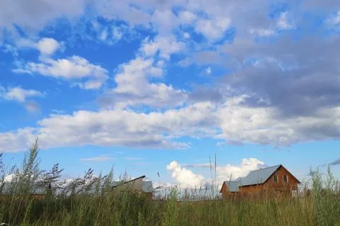 Large white clouds in the blue sky above a village in Russia Foto stock
