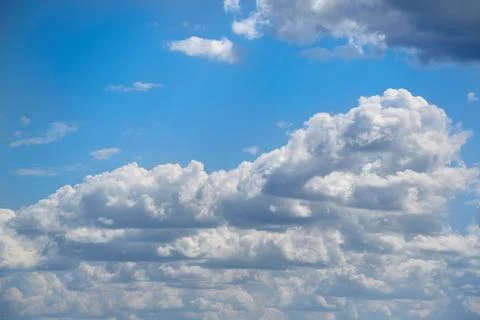 Large white clouds in a single row in the sky, blue sky with clouds Stock Photos