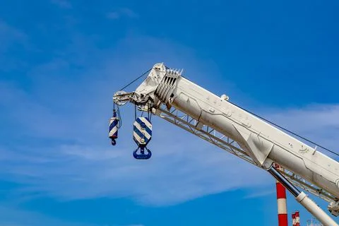 Large white crane with a white cloud background of blue sky Stock Photos