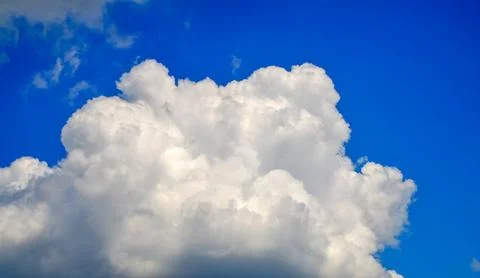 Large White Cumulus Cloud Against Blue Sky Stock Photos