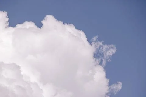 Large white cumulus cloud against a blue sky with copy space 스톡 사진