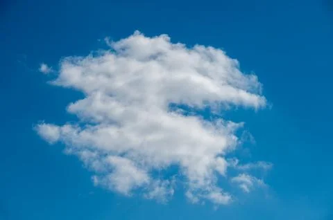 Large White Cumulus Cloud Against a Clear Blue Sky Stock Photos